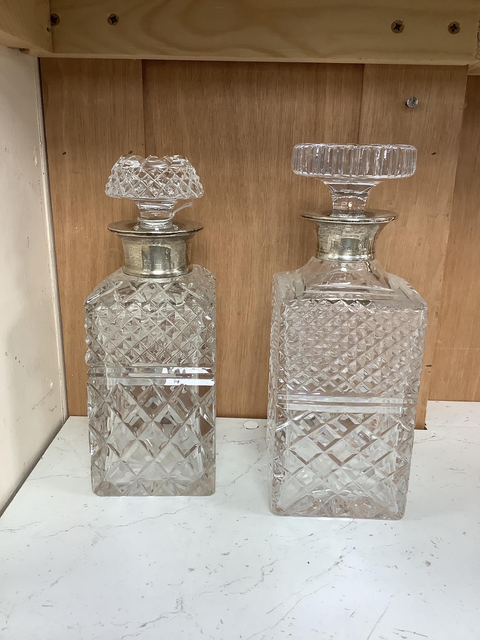 Two silver collared cut glass decanters, tallest 24.5 cm high